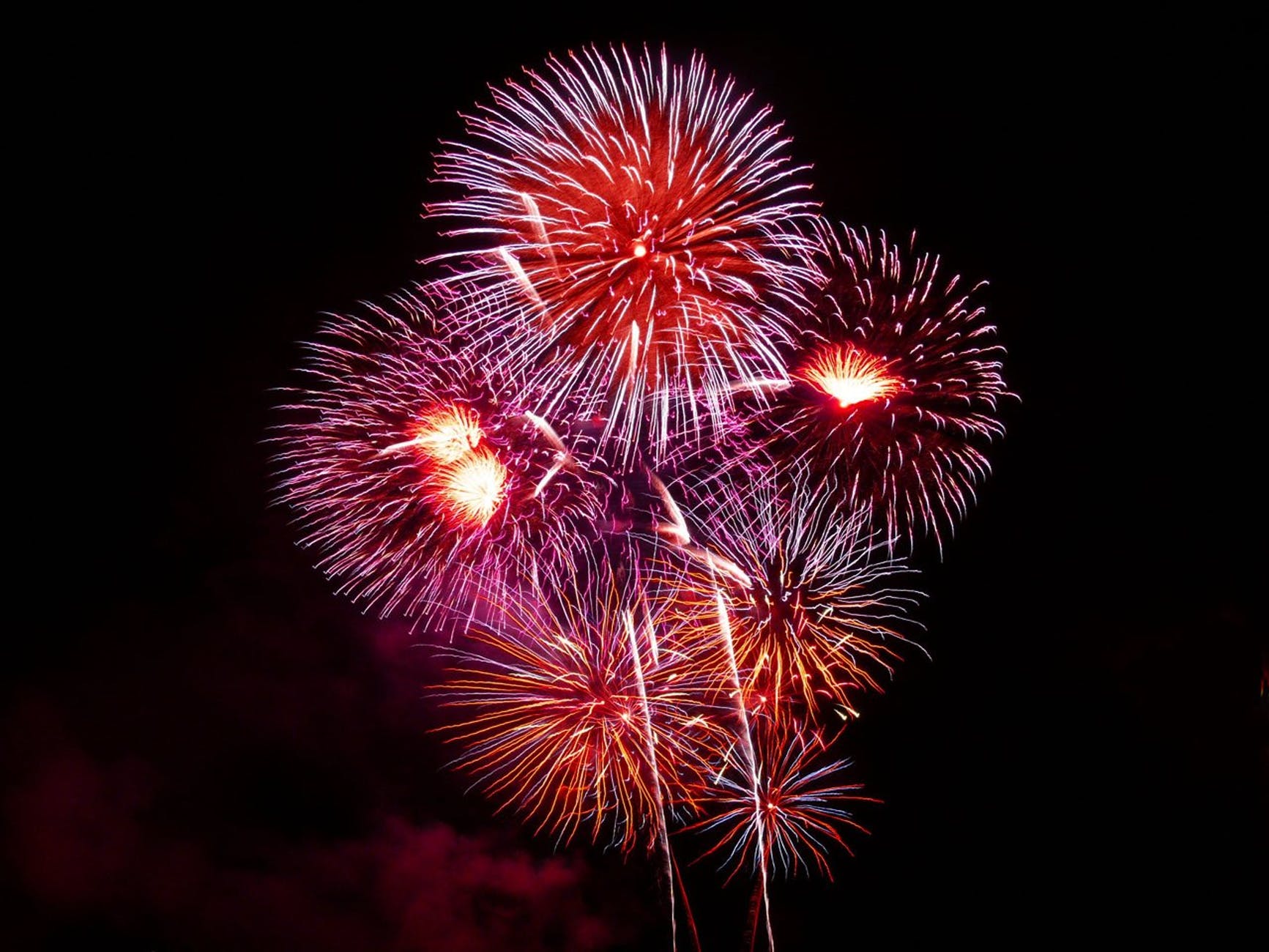 purple red white and orange fireworks display